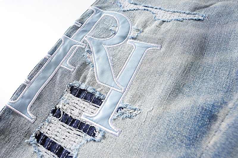 AMIRI Light Blue Letter Graphic Distressed Jeans — detail